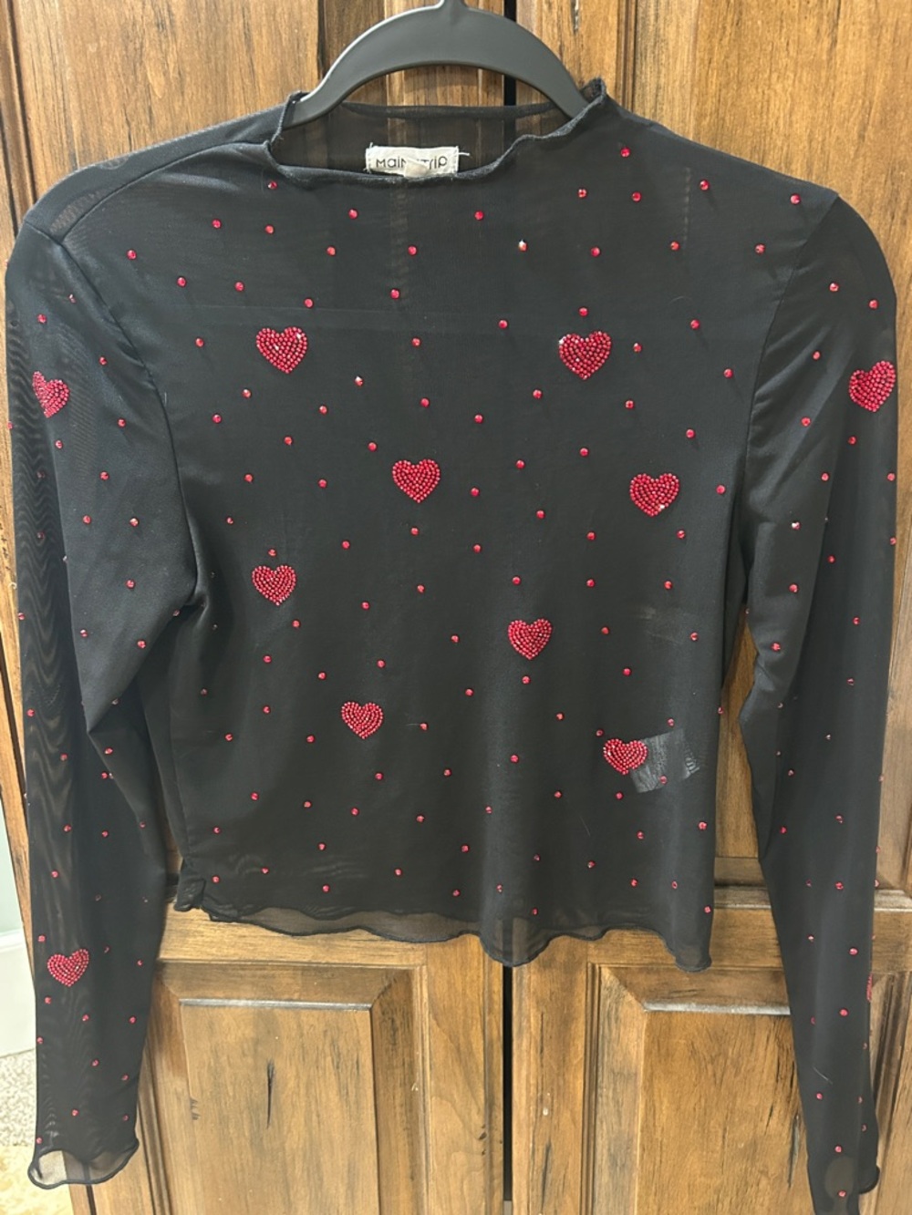 Main Strip Black Sheer Long Sleeve Top with Red Heart Embellishments